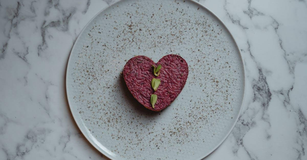 Heart-shaped beetroot dish with garnishing on a plate, perfect for a romantic vegan meal.